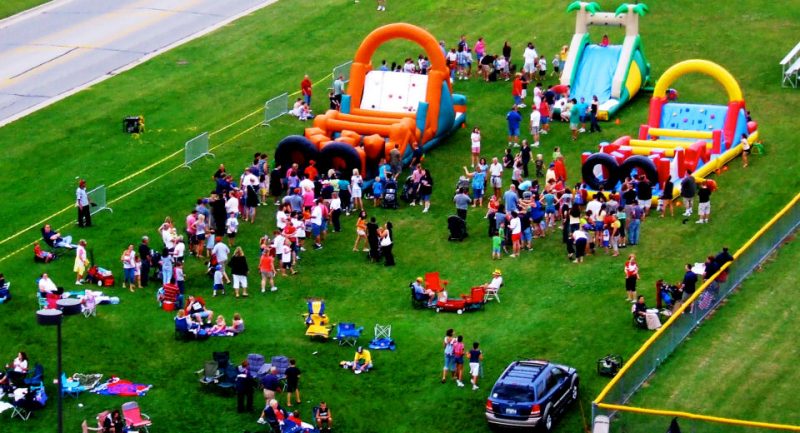 People & Inflatables At A Company Picnic