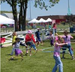 kids involved in a hula hoop contest at an end of the school year celebrations